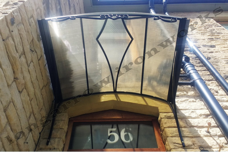 metal and polycarbonate arched door canopy