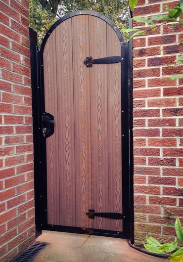 Arched pedestrian garden gate, metal frame and composite boards infill