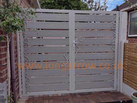 fancy bespoke wrought iron and composite driveway gate in halton leeds