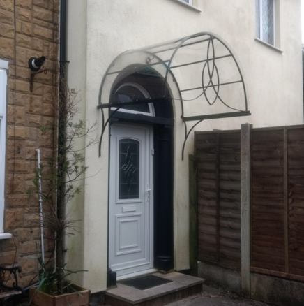 wrought iron arched door canopy