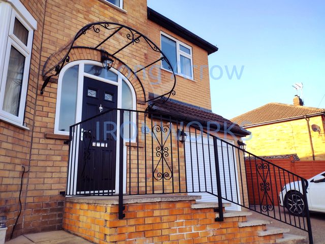 Arched wrought iron door canopy in Leeds, West Yorkshire