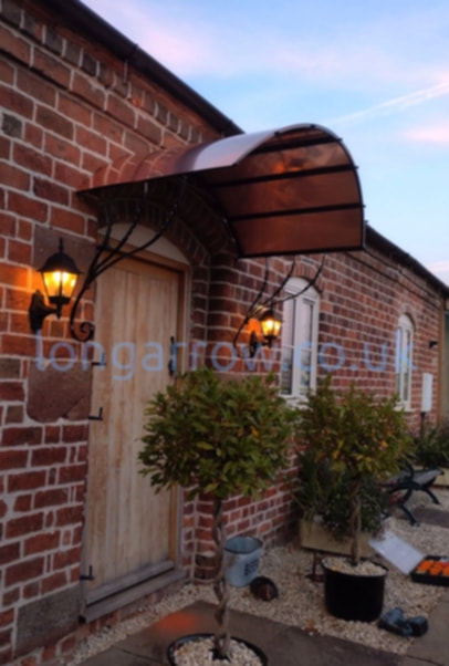 wrought iron and copper door canopy